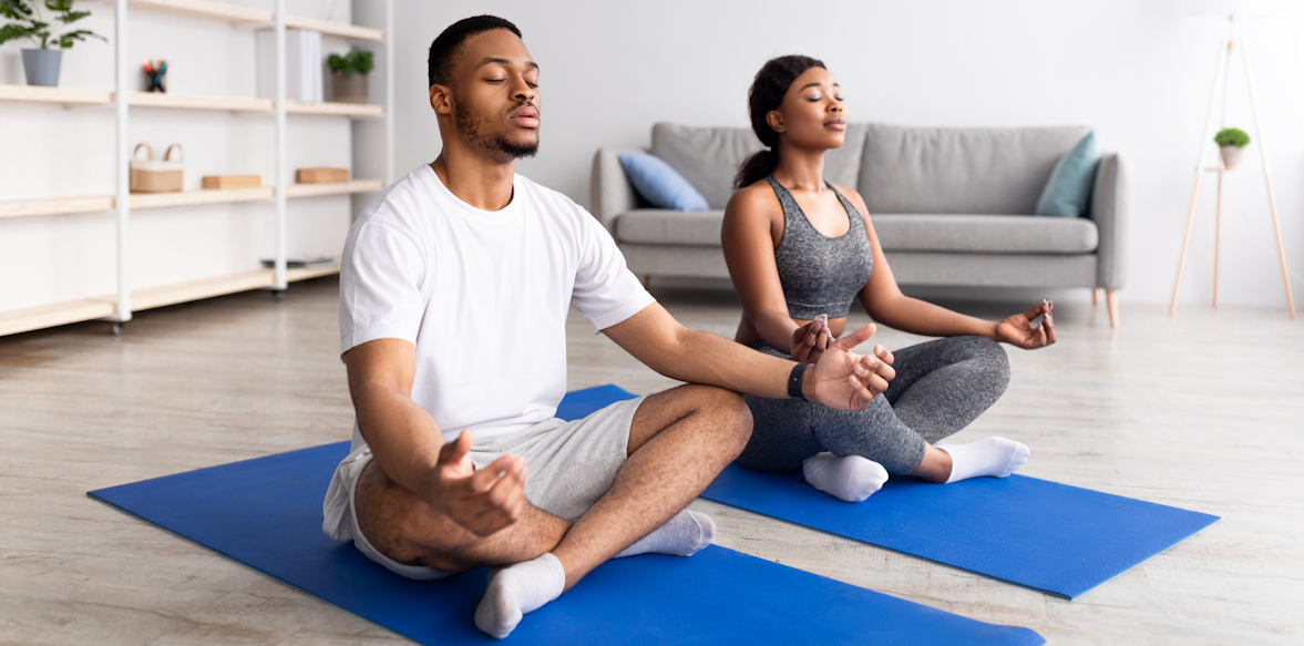 Couple Doing Yoga to Relax at Home